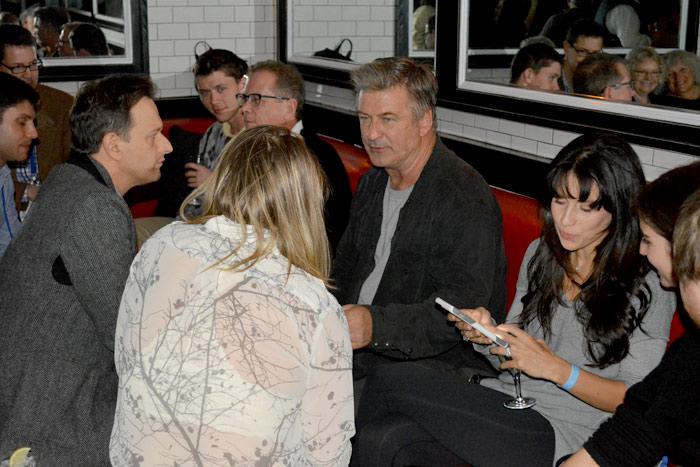 Alec Baldwin, sitting with wife Hilaria Thomas Baldwin, chats with Josh Charles