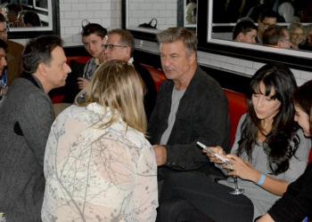 Alec Baldwin, sitting with wife Hilaria Thomas Baldwin, chats with Josh Charles