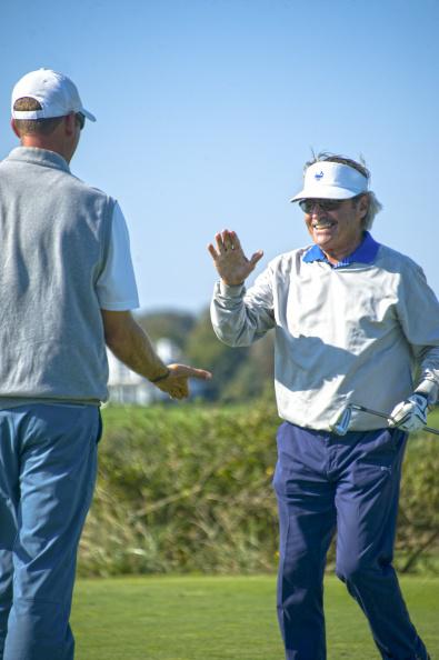 Dr. Rob Jarmain, high five-ing the pro, Jayson Jeffries, after landing his shot on the green, closer to the pin, beating the pro, winning the special challenge.