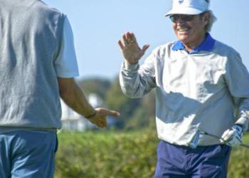 Dr. Rob Jarmain, high five-ing the pro, Jayson Jeffries, after landing his shot on the green, closer to the pin, beating the pro, winning the special challenge.