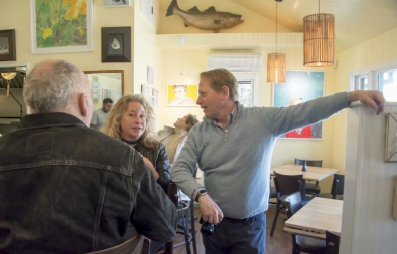 Sampling Estia's delicious hors d'oeuvers and wine, painter Paton Miller speaks with poet Ingrid Torjesen and proprietor Colin Ambrose at the opening of the current exhibit of the paintings of Valerie Suter.