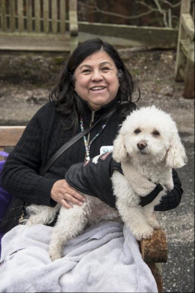 Luzmila Gonzalez snuggles her dog Luca, a 7 1/2-year-old mix, listening to the music and enjoying the warmth of her little friend at ARF's Pet Celebration Day