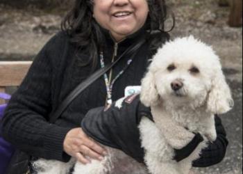 Luzmila Gonzalez snuggles her dog Luca, a 7 1/2-year-old mix, listening to the music and enjoying the warmth of her little friend at ARF's Pet Celebration Day