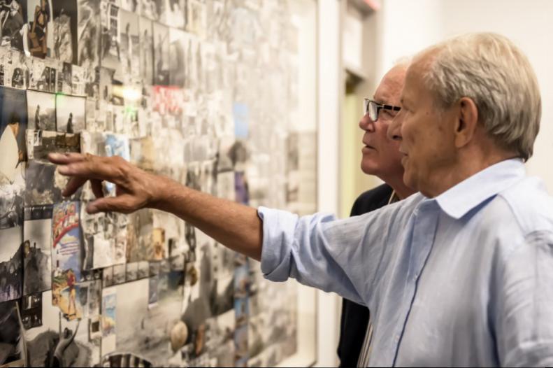 Artist Peter Beard and his brother, Anson, reminisce over a large collage of images from the years spent in Montauk.