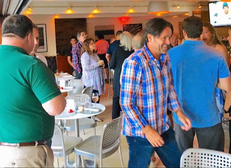 Jim Rooney, (center of photo); principal of FLEXdevelopment/Broker KP Property Group Inc. greets his guests with a big smile and a casual "meet and greet" held at Cittanuova in East Hampton.