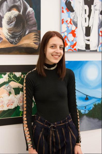 Award recipient Madison of Westhampton Beach HS stands next to her artwork