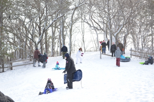 Local kids came out with their parents on Saturday to go sledding on a hill next to Newtown Road in Hampton Bays.