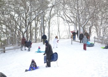 Local kids came out with their parents on Saturday to go sledding on a hill next to Newtown Road in Hampton Bays.