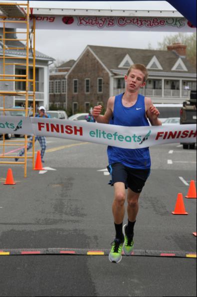 First place male winner crosses the finish line