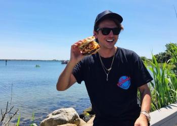 GrillHampton host Jonathan Cheban the @foodgod himself at Montauk Yacht Club ​eating their signature burger from Coast Kitchen