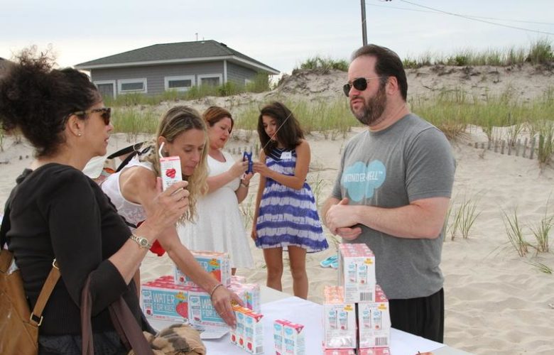 Gregg Lefkowitz hands out Wonder + Well, organic flavored water in various flavors for kids to enjoy as a healthy alternative