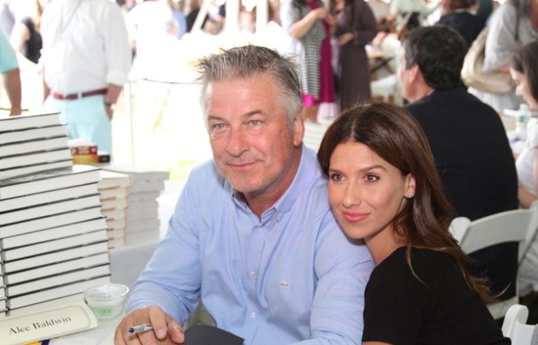 Alec and Hilaria Baldwin canoodle at their table