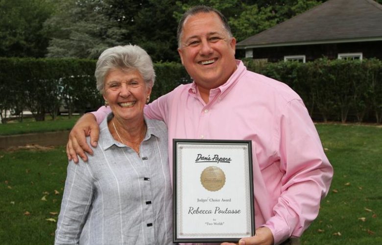 Jody Flynn, grandmother of Judges' Choice Award Winner Rebecca Poutasse, accepts the award on her behalf, CEO and Editorial Director at Dan's Hamptons Media Eric Feil
