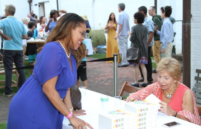 Author Gail Sheehy speaks with a fan while signing her book
