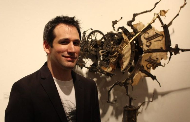 Artist Eric Freitas with one of his creations