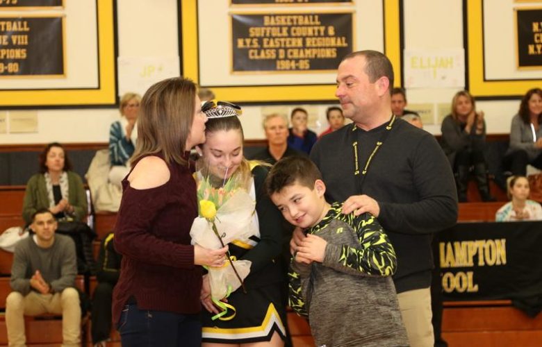 Elena Giosi and her family celebrate Senior Recognition Night at the game
