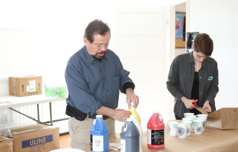 Artist Francisco Alvarado-Juarez with his assistant Camila Marichal prepared paint for the attendees