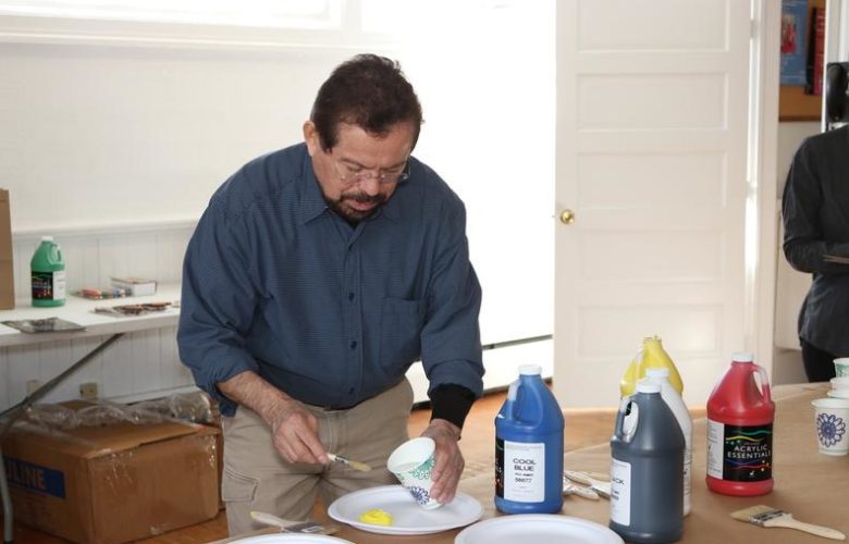 Artist Francisco Alvarado-Juarez instructed attendees on how to properly mix acrylics with water in order to create the perfect consistency for the paper bags