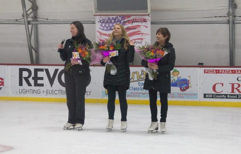 Jessica Kellis, Liz Mendelman and Joanne Doran receive flowers from the student body