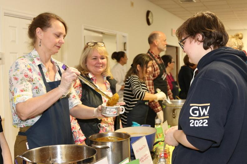 Volunteer Jen Edwards serves delicious soup to Will, age 17