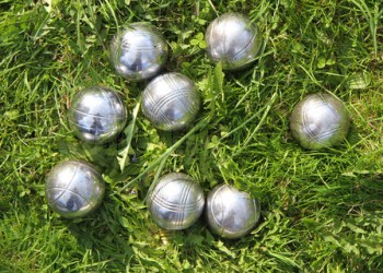 petanque bowls in the green grass