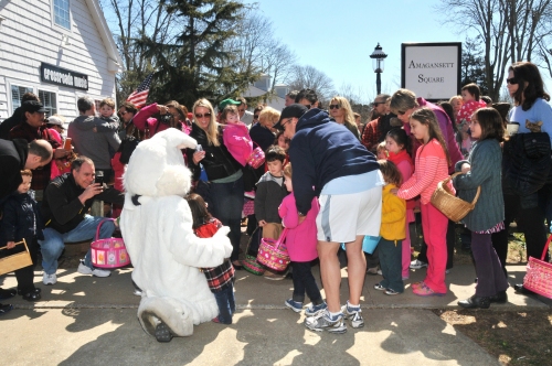The crowds rush to pose with the Easter Bunny, the star of the day