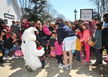 The crowds rush to pose with the Easter Bunny, the star of the day