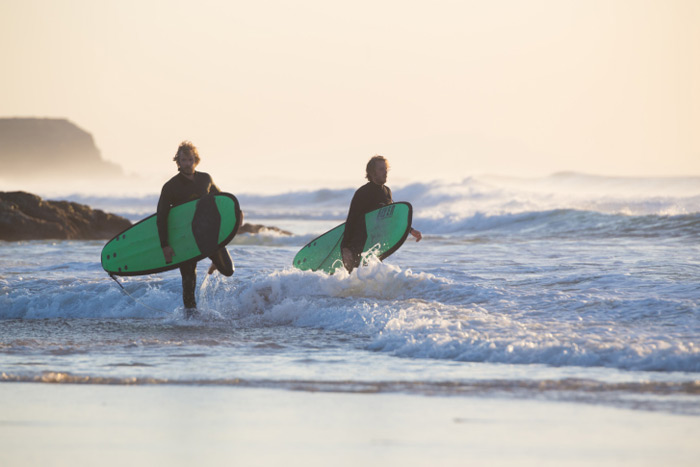 Two surfers in fullsuits