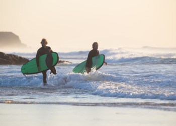 Two surfers in fullsuits