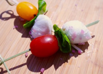 Skewer of mozzarella, cherry tomatoes, and green basil, seasoned with Amagansett Sea Sal