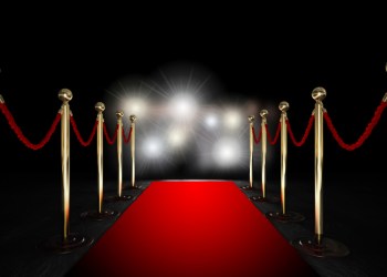 Rope barrier with red carpet and flash light