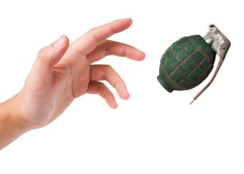 hand throwing a green grenade on white