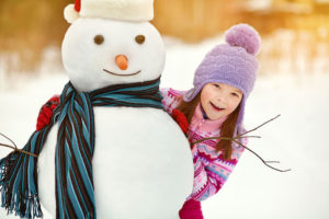 little girl with snowman