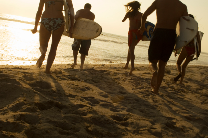 Group of Surfers Walking on Beach