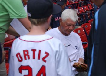 Carl Yastrzemski signs an autograph for a fan at Fenway Park in 2008.