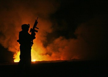 Soldier by firelight burn pit