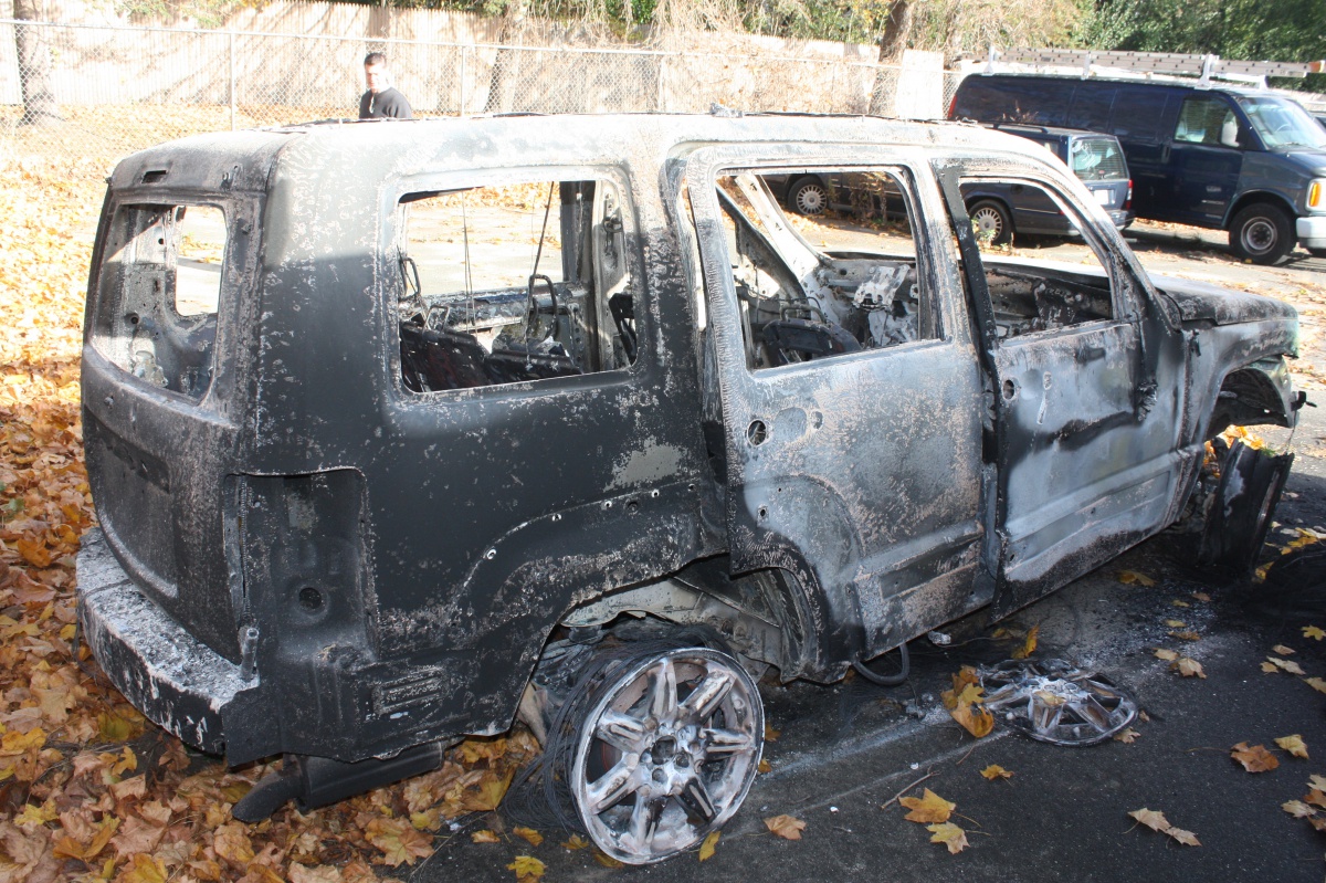 Police say burglars stole and burned this Jeep Liberty.