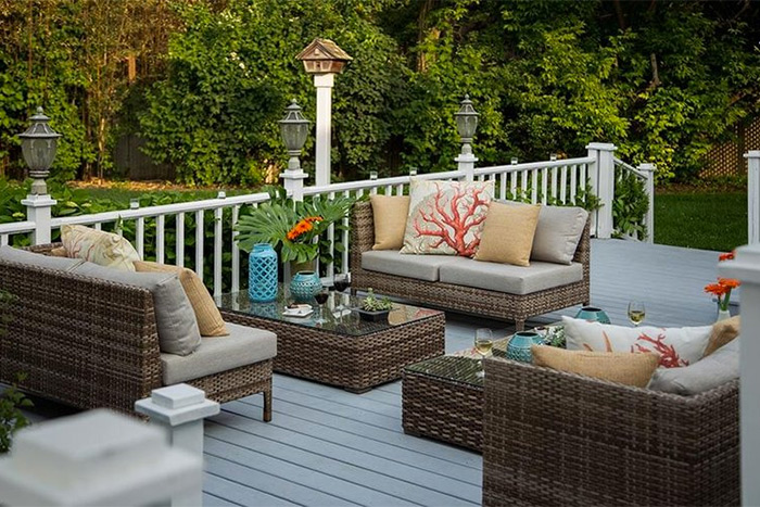 outdoor dining area, porch with wicker couches and pillows