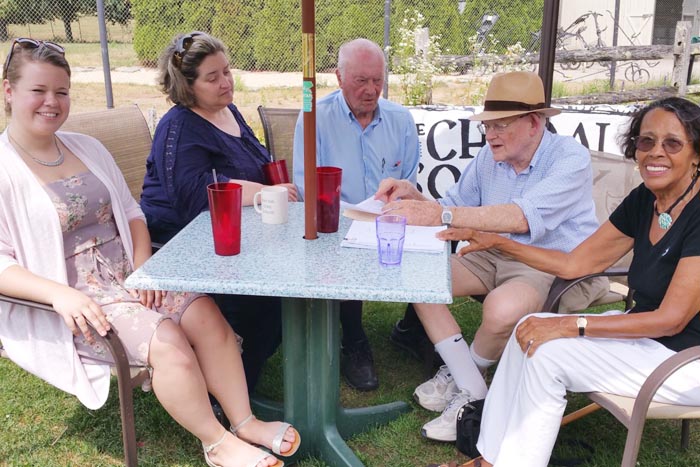 Singing themselves out to the ball game, members of the Choral Society of the Hamptons meet at the Poxabogue restaurant with Leif Hope, organizer of the 67th Artists & Writers Charity Softball Game to discuss their forthcoming performance of the National Anthem before the first pitch. From left: Gwen Clarke; Christine Cadarette, arranger and conductor; Hope; Chris Cory; and, Mary Ann Whitehead.