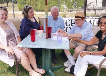 Singing themselves out to the ball game, members of the Choral Society of the Hamptons meet at the Poxabogue restaurant with Leif Hope, organizer of the 67th Artists & Writers Charity Softball Game to discuss their forthcoming performance of the National Anthem before the first pitch. From left: Gwen Clarke; Christine Cadarette, arranger and conductor; Hope; Chris Cory; and, Mary Ann Whitehead.
