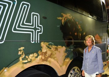 Lynn Mara in front of her winning Hampton Jitney wrap design.
