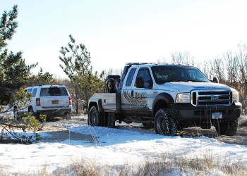 A stuck Jeep SUV is pulled out of a rut on Road G.