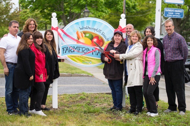 Westhampton Chamber of Commerce President Roberta Shoten and Westhampton Beach Mayor Maria Moore cut the ribbon at the Westhampton Beach Farmers' Market, along with the Chamber of Commerce board members and the village trustees.