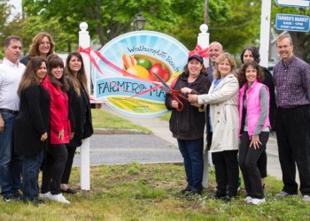 Westhampton Chamber of Commerce President Roberta Shoten and Westhampton Beach Mayor Maria Moore cut the ribbon at the Westhampton Beach Farmers' Market, along with the Chamber of Commerce board members and the village trustees.
