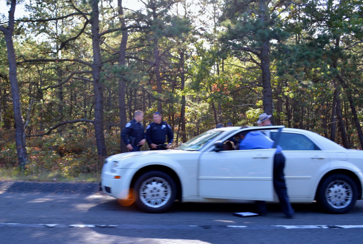 Detectives investigate the Flanders shooting suspects' vehicle.