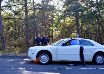 Detectives investigate the Flanders shooting suspects' vehicle.
