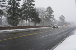 Vehicles drive on County Road 39 in Southampton Friday morning in snowy conditions.