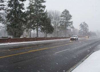 Vehicles drive on County Road 39 in Southampton Friday morning in snowy conditions.