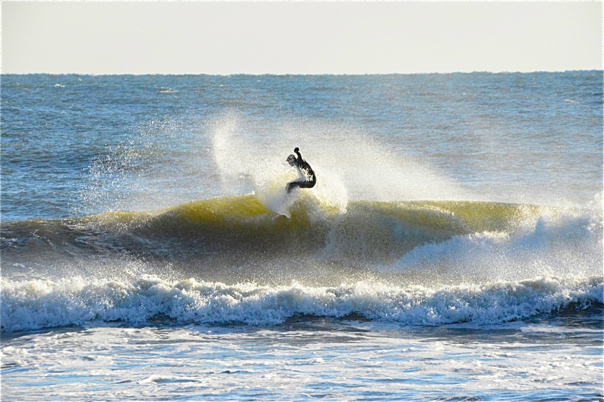 Surfer surfing surfboarding surf board in the Hamptons