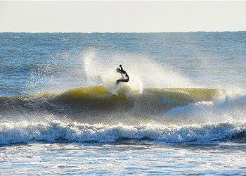 Surfer surfing surfboarding surf board in the Hamptons